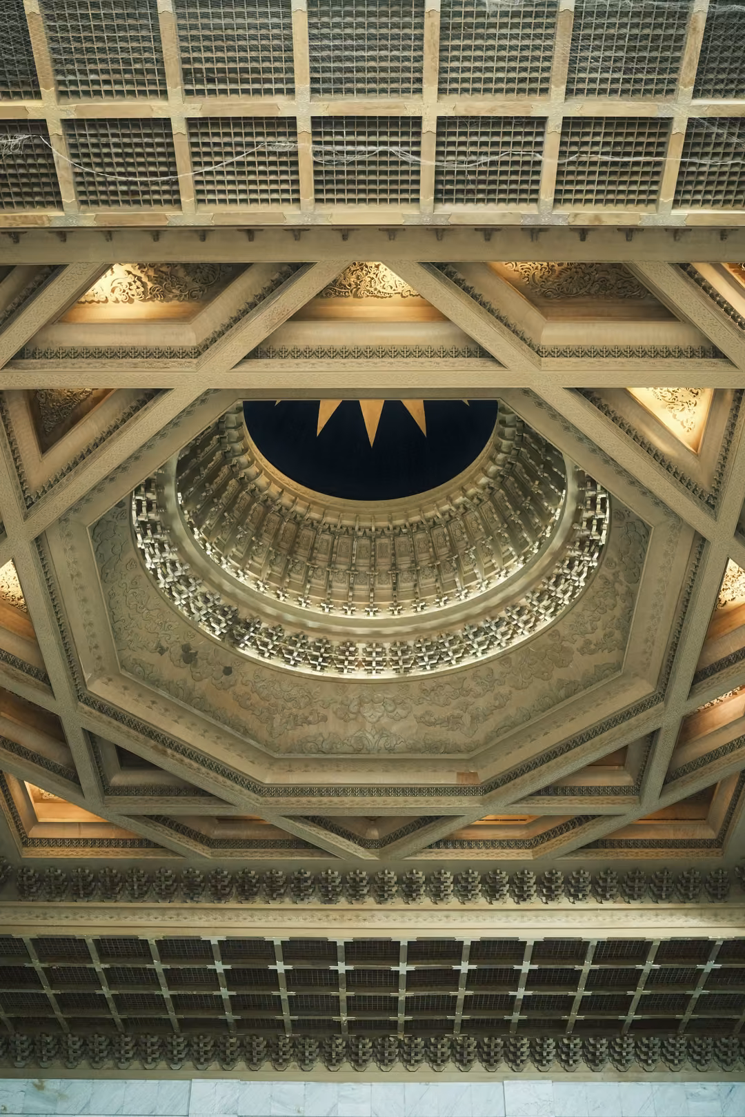 Ornate octagonal ceiling with gold coffers and a deep blue centre, viewed directly from below